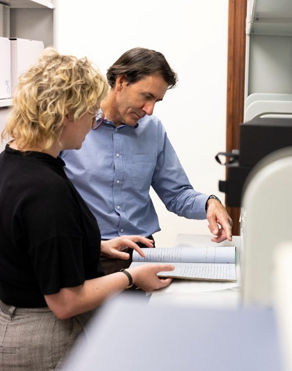 Our Donors Julian Burt, takes a closer look at Archibald Paull Burt notebooks, with the Museum Curator during a digitisation session.